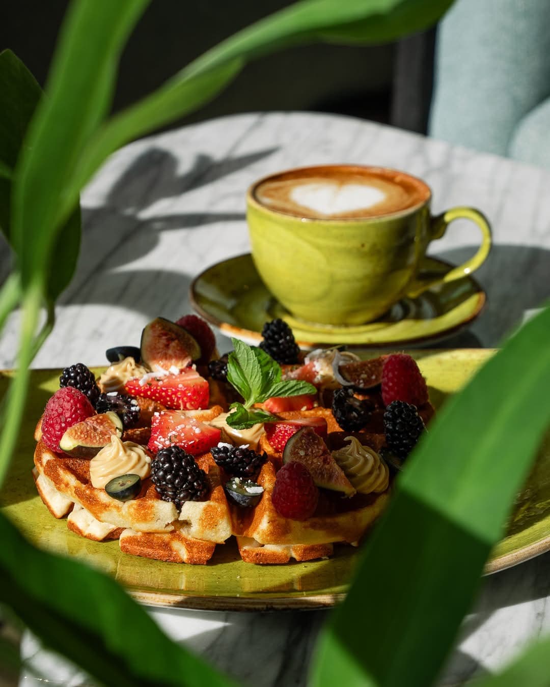 Breakfast with fresh berries and a cappuccino